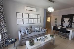 a living room with a couch and a table at Jasmine - Apartment in Kalamata in Kalamata