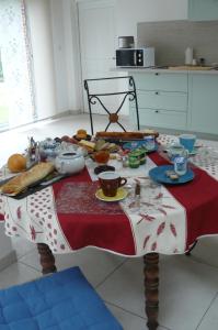 un tavolo con una tovaglia rossa e bianca con sopra del cibo di Le fief Beaurepaire 76280 a Beaurepaire