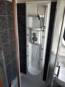 a shower stall with a toilet in a bathroom at Central Lovely House in Montepulciano +8 photos