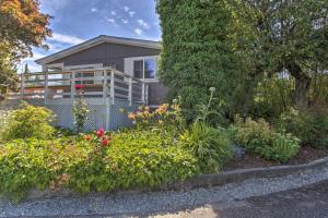 a house with a garden in front of it at Cute Cottage with Deck Walk 115 Ft to Brewery and Cafe in Poulsbo