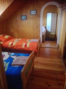 a small room with two beds and a hallway at Stadnina koni Tarka in Zwierzyniec