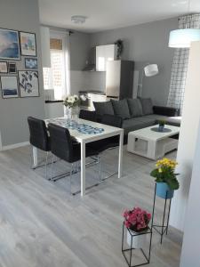 a kitchen and living room with a table and chairs at ArenaStreet Apartmani in Pula