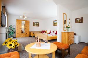a living room with a table and a bedroom at Pension Minor in České Budějovice