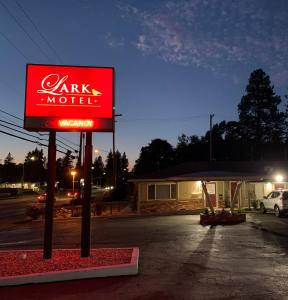 a sign for a car motel in a parking lot at Lark Motel Willits in Willits