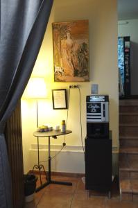 a living room with a television and a painting on the wall at Hostal Europa in Barcelona