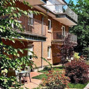 a brick building with a table and a balcony at Ferienpark Thüle in Friesoythe