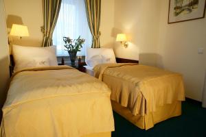 Posteľ alebo postele v izbe v ubytovaní Hotel Mignon