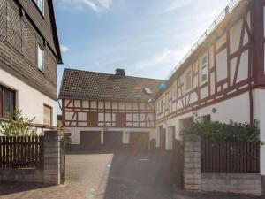 a building with a fence next to a street at Wohnung in Battenberg nahe Winterberg Skigebiet in Battenberg +32 photos