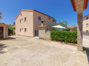 an empty driveway in front of a house at Spacious Holiday Home in Peroj with Private Pool in Peroj