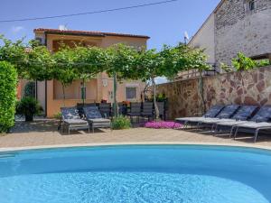 a swimming pool in front of a house at Spacious Holiday Home in Peroj with Private Pool in Peroj