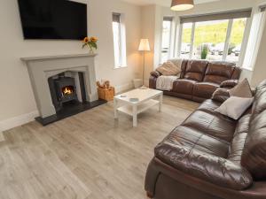 a living room with a couch and a fireplace at Greystones in Llandudno