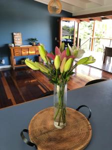 a vase filled with flowers sitting on top of a table at Timbertop for Life in Gold Coast