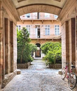 a bike parked under an archway in a building at BpR Auric Home in Budapest