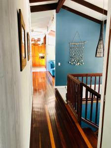 a room with a wooden floor and a blue wall at Timbertop for Life in Gold Coast