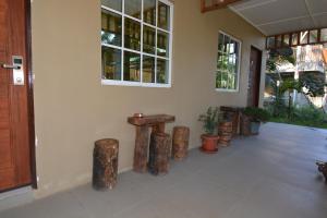 a room with wooden stools and a wall with windows at Hemingway Cottage 海明威度假屋 in Semporna