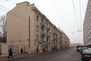 a group of people walking down a street next to a building at Kvartira Leningradskaya 5 in Minsk