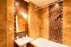 a bathroom with a sink and a tub and a shower at Kvartira Leningradskaya 5 in Minsk