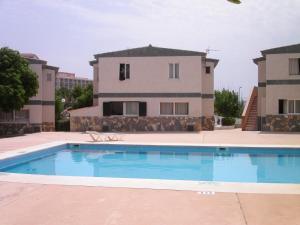 une grande piscine en face d'un bâtiment dans l'établissement TRANQUILO APARTAMENTO con preciosa cala en la puerta, à Ciutadella