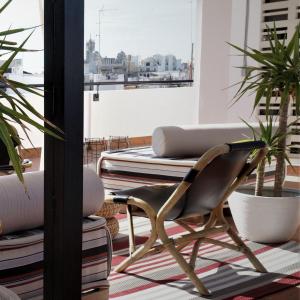 a chair in a room with potted plants at MD Design Hotel - Portal del Real in Valencia