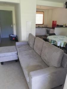 a living room with a couch and a table at Duplex Alexandra Ray Luis in Rémiré