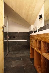 a bathroom with a shower and a sink at Hotel am Römerweg in Fiss
