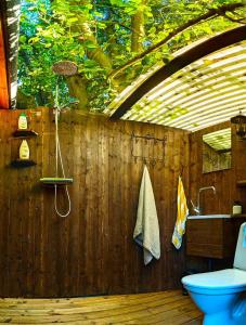 a bathroom with a wooden wall and a toilet at Fiskargränd 5 in Visby
