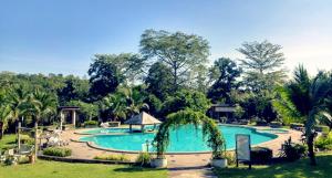 una gran piscina en un patio con árboles en Nakakiri Resort & Spa, en Hin Dat