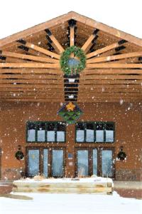 a house with a potted plant on the front of it in the snow at The Inn at Silvercreek in Granby