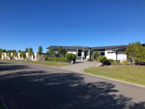 a house on a street with a driveway at Wilsons Retreat - Hosts On-site in Eskdale