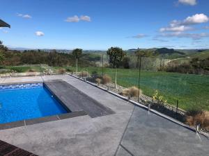 a swimming pool in the backyard of a house at Wilsons Retreat - Hosts On-site in Eskdale