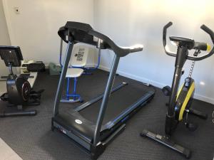 a gym with two exercise bikes and a treadmill at Wilsons Retreat - Hosts On-site in Eskdale