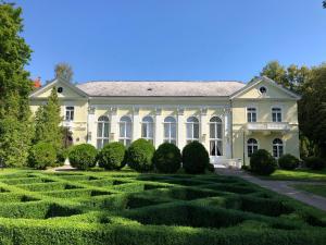 a large white house with a garden in front at Jodła i Modrzew in Jelenia Góra