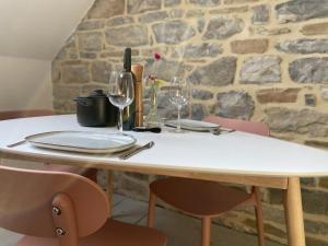 a white table with wine glasses on top of it at Fenêtre sur Theux in Theux