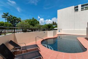 a swimming pool on the roof of a building at Cairns Ocean View Apartment in Aquarius in Cairns