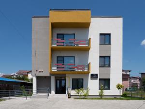 a building with balconies on the side of it at Clement Apartments in Piatra Neamţ
