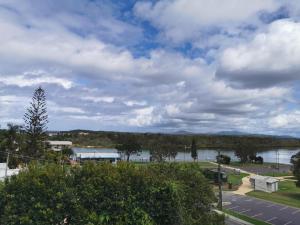 
a large body of water surrounded by trees at Riverview Boutique Motel in Nambucca Heads
