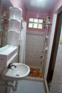 a bathroom with a sink and a shower at Villa Prescilla in Dumaguete