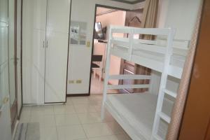 a room with two bunk beds and a hallway at Villa Prescilla in Dumaguete