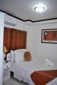 En eller flere senger på et rom på Villa Prescilla