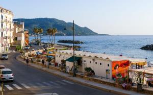 a view of a street with the ocean and buildings at Pepi B&B in Santa Maria di Castellabate
