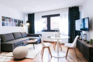 a living room with a couch and a table at EIFFEL BRIDGE BOUTIQUE APARTMENT in Girona