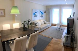 a living room with a dining table and a couch at Apartamento Mercedes in Logroño