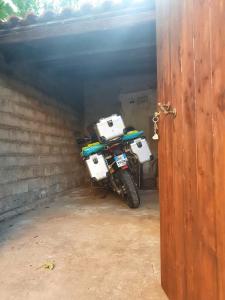 a motorcycle parked in a garage next to a door at Casa Elvira in Baratili San Pietro