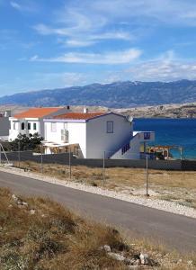 a white building on the side of a road at VILLA AROMA in Pag