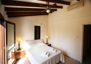 a bedroom with a bed and a ceiling fan at Pissouri Bay Villa in Pissouri