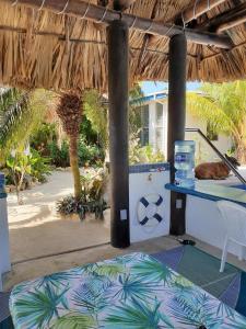 a room with a bed and a table with a table at The GECKO BUNGALOW**Beautiful POOL**Free Airport Shuttle in Belize City