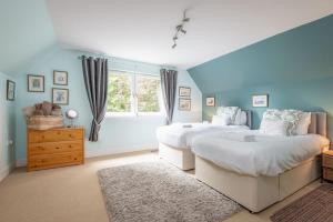 a bedroom with two beds and a window at Muir Park Cottage , 5 Mins to St Andrews , Parking in St Andrews