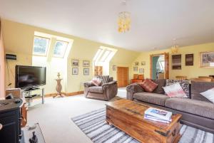 a living room with a couch and a coffee table at Muir Park Cottage , 5 Mins to St Andrews , Parking in St. Andrews