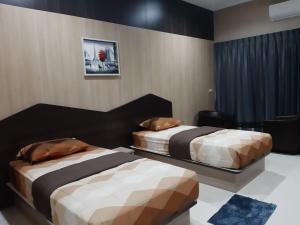 a bedroom with two beds in a room at Tho Mai Resort in Wang Chan