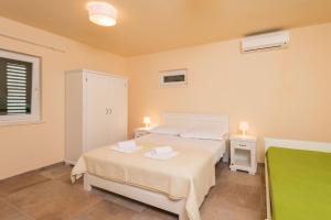 a bedroom with two beds and a window at Villa Sandra in Lumbarda +34 photos